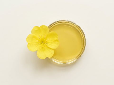 Gelbe Nachtkerzenblüte neben goldgelbem Nachtkerzenöl